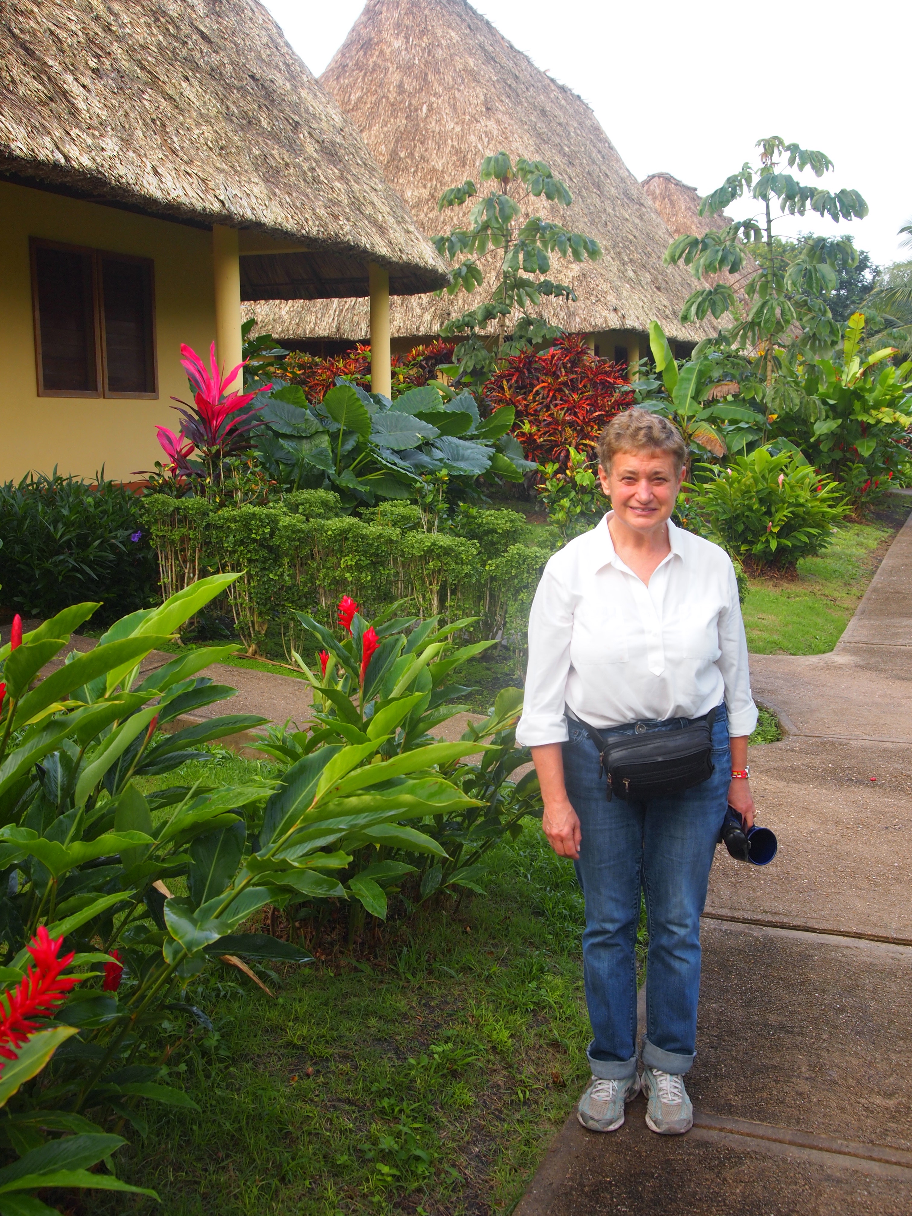 Lucy in front of our thatched cabin at Casa del Blanco Caballo